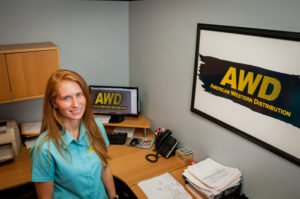 Woman Standing At Desk - American Western Distribution
